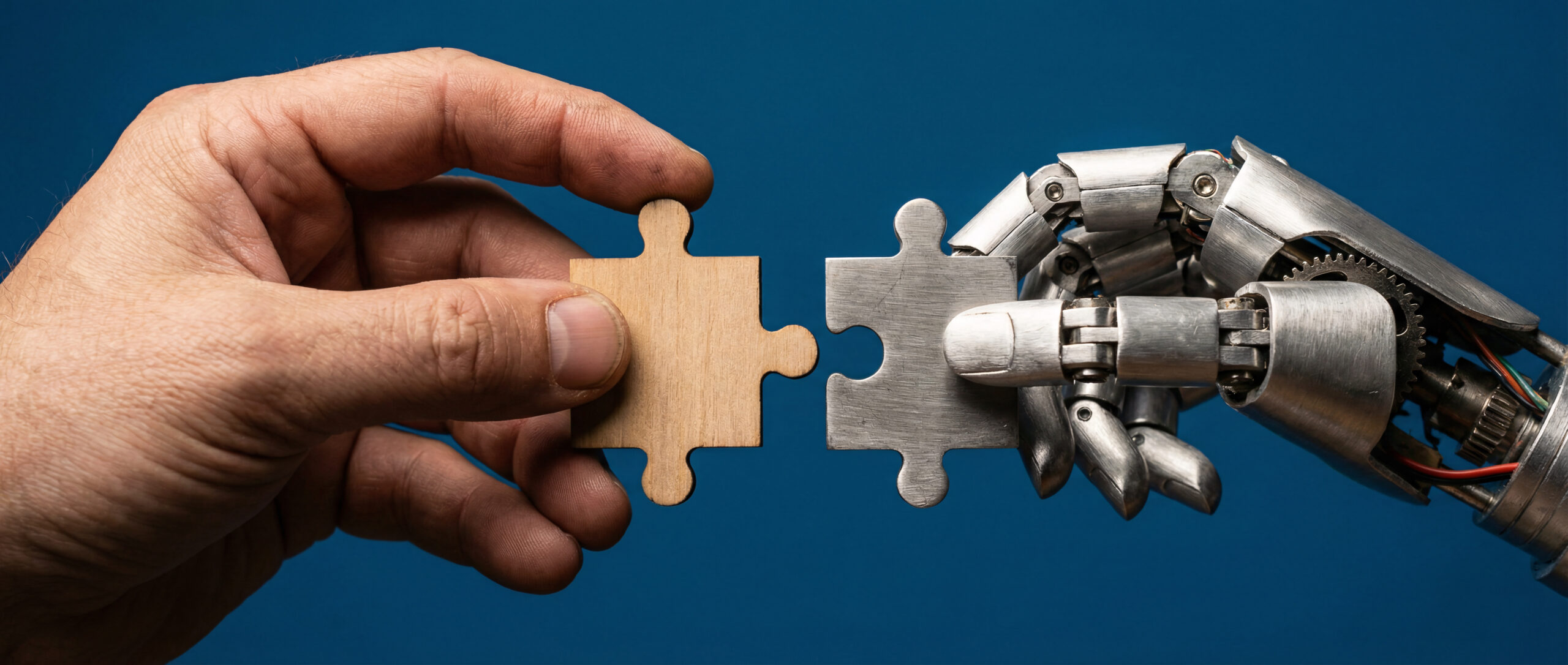 ART1_human-robot-hands-connecting-wooden-digital-puzzle-pieces-ai-collaboration-concept
